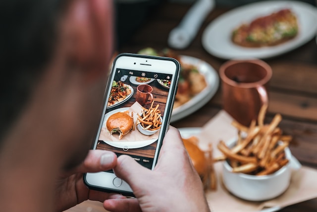 Gen Z taking picture of food with phone